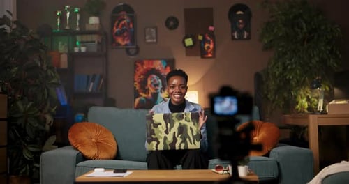 Illustrator or Storyboard Artist African Woman Seated in Her Living Room Draws and Writes with