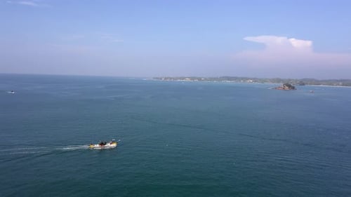 Aerial tracking shot of fisherman boat in Weligama, Sri Lanka