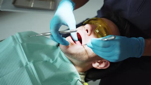 Dentist Examining Patient's Teeth
