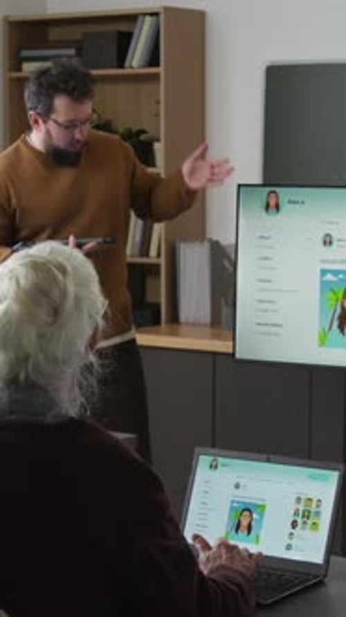 Vertical Shot of Teacher Explaining Social Media to Seniors