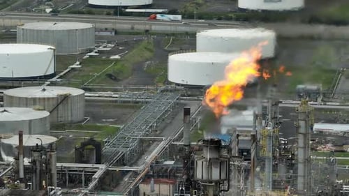 Oil refinery aerial of flames in front of industrial background_1