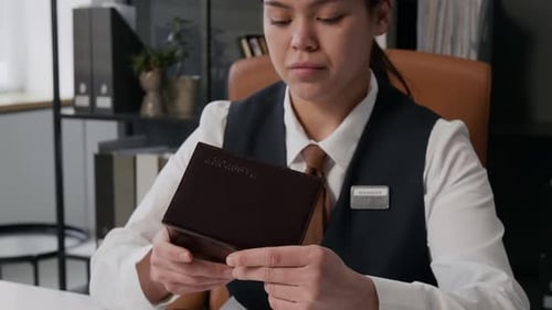 Bank Employee Checking Passport at Office Table