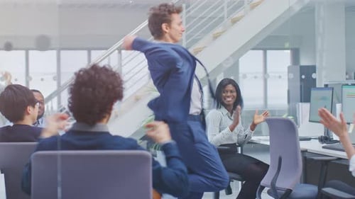 Young Cheerful Handsome Business Manager Wearing a Suit and Tie Dancing in the Office. Diverse and