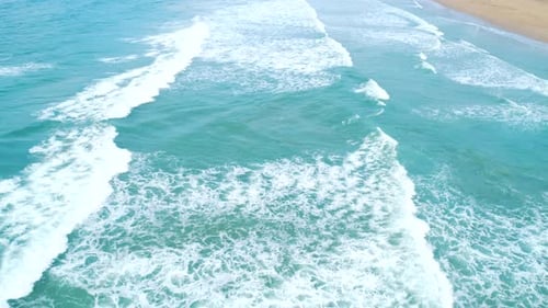 Aerial View of Tropical Sandy Beach and Blue Ocean Top View of Ocean Waves Reaching Shore on Sunny