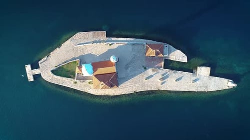 Aerial: Top down view of Island of Saint George Benedictine Monastery in Bay of Kotor, Montenegro