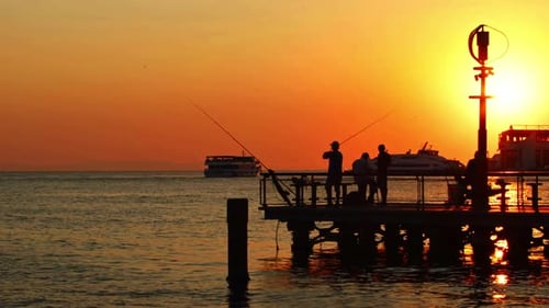 Fishermen Fishing On The Harbor Beach At Sunset 2