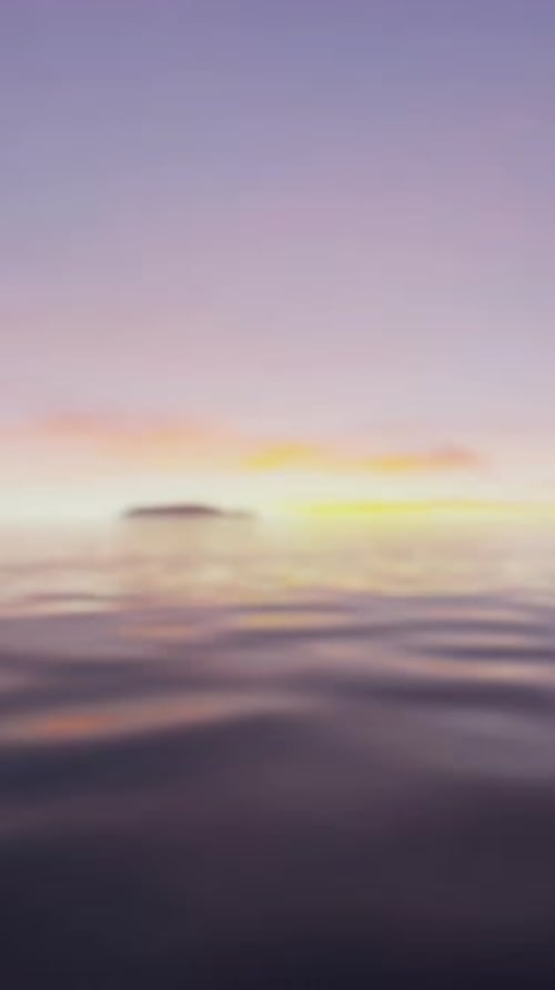 A Blurry Photo of the Sun Setting Over a Body of Water