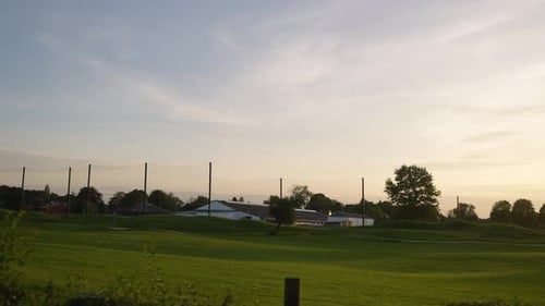 An Expansive Golf Course Panorama at sunset - Aerial Panning