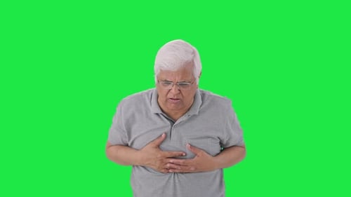 Sick Indian old man suffering from cold and cough Green screen