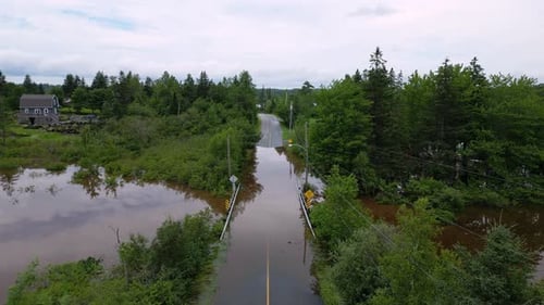 Natural disaster river flooding closed road due to bridge submerged underwater