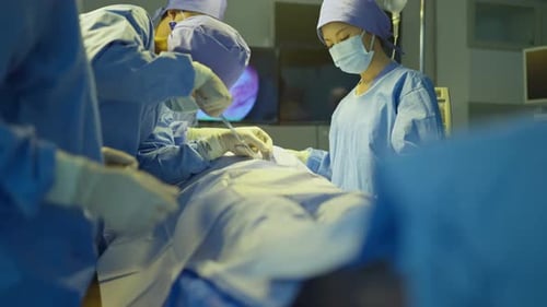 Doctor and nurse team help to treat patient lie on bed in operation of the hospital and they work