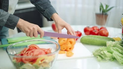 Woman Slicing Bell Pepper for Salad at Home