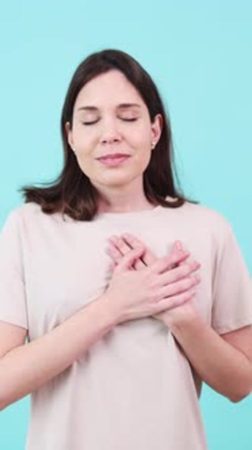 Woman Showing Love and Gratitude with Hands on Chest