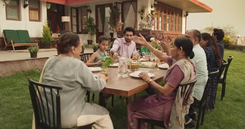 Big Indian Family Garden Party Celebration, Gathered Together at the Table in Ba