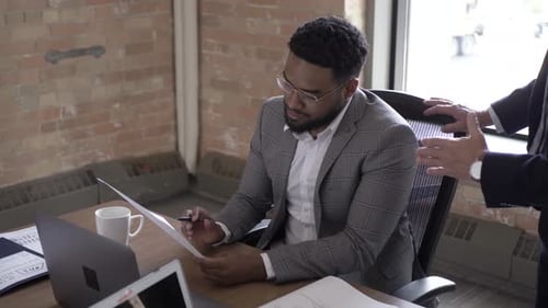 Team Discusses Business Documents at Modern Office