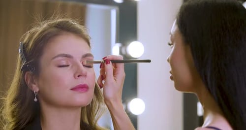 Footage of a Make Up Artist Work in Her Beauty Studio with Client Slow Motion Footage