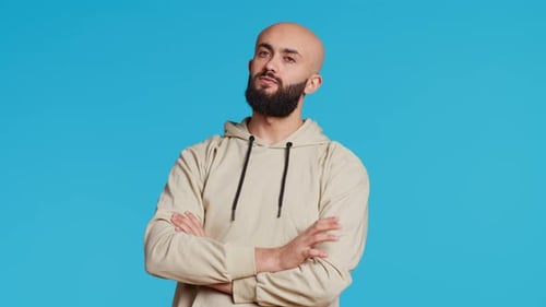 Young Adult in a Hoodie Waiting for Something in Studio