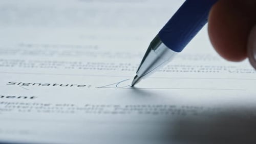 Signing Legal Document with Pen in Close Up
