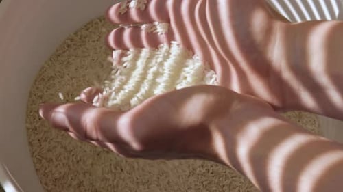 Two hands holding many grains of raw rice in bucket,close up