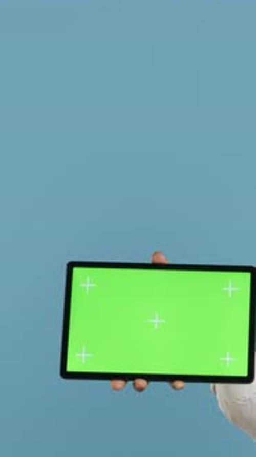 Vertical Video Doorkeeper Bellboy Poses with Green Screen on Tablet at the Hotel Reception