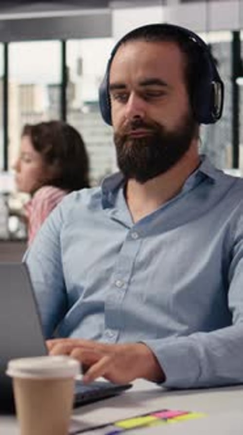 Vertical Video Headphones in Office Working with Focus Music Business Employee at Desk
