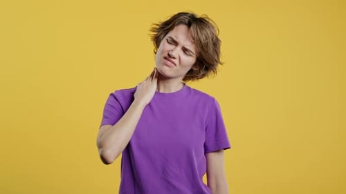 Woman Experiencing Neck Pain in Studio