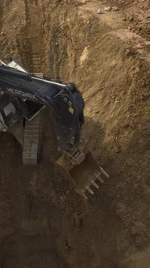 Excavator Digging Trench From Aerial Birds Eye View