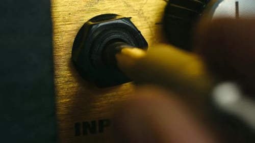 Plugging Yellow Audio Cable into Guitar Amplifier Input