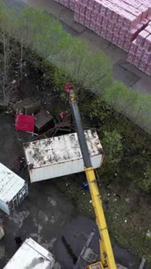 Aerial View of Crane Lifting at Industrial Site