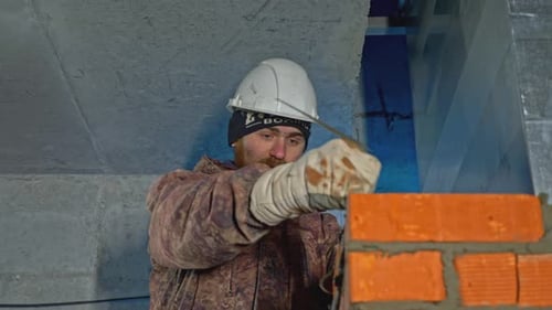 Bricklayer with Beard Constructing a Brick Wall