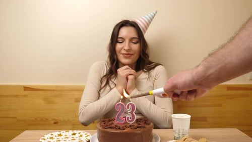 Woman Celebrating Birthday Blowing Out Cake Candles
