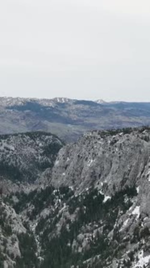 Vertical Video Cinematic Winter Landscape Aerial View of Mountains River and Small Waterfalls