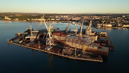 Aerial view of shipyard with cranes and vessels, Croatia.