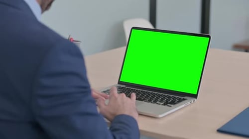 Businessman Using Laptop with Green Screen