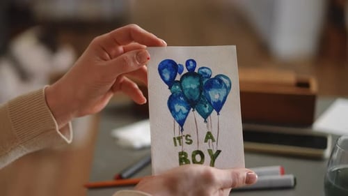 Holding It's a Boy Card with Blue Balloons