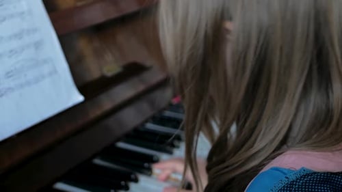 Young Girl Plays Piano at Home
