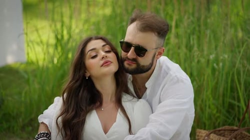 Loving Couple Embracing in a Grassy Field