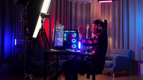 Asian Boy Streamer Celebrating Winning Game On Computer. Live Stream Video Game