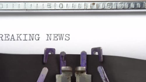Typewriter Typing Breaking News on White Paper