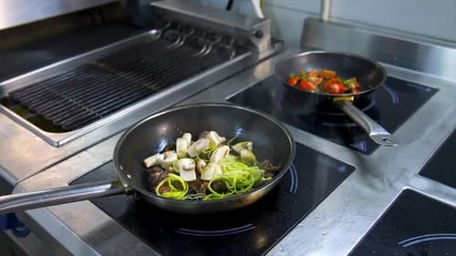 Vegetables Cooking in Frying Pans on Stove