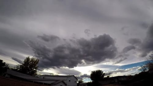 Go Pro timelapse video of clouds going by. Cloudy day blocks sunlight. Dark clouds blowing by