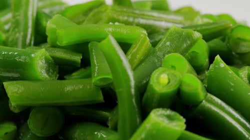 Fried Wok Green Beans with Onions and Spices in a White Plate on a Gray Background Flat Lay Top View
