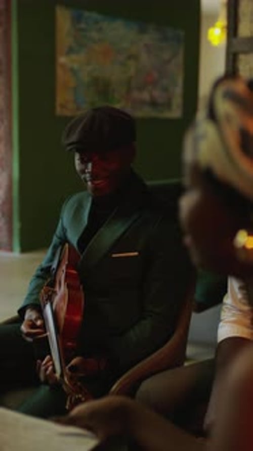 Man Plays Violin in Dark Setting