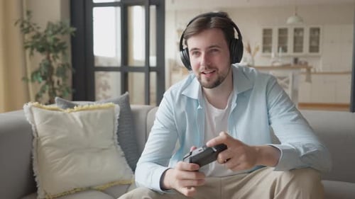 Man Enjoying Video Game at Home on Couch