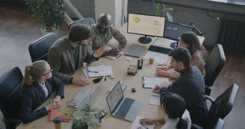 High Angle View of Businesspeople Talking Joining Hands Together Expressing Unity Focused on Team