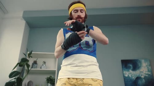 Man Wrapping Wrists for Boxing Workout at Home