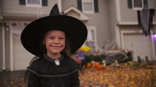 Smiling Girl in Witch Costume on Halloween