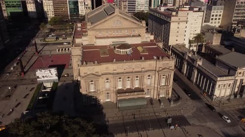 Aerial tracking shot of ancient building of Teatro Colon lighting by sunlight - Famous architecture