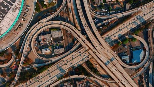 Los Angeles interchange with numerous cars moving by.