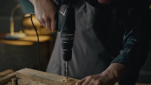 Close up Adult Drilling a Hole in Wood